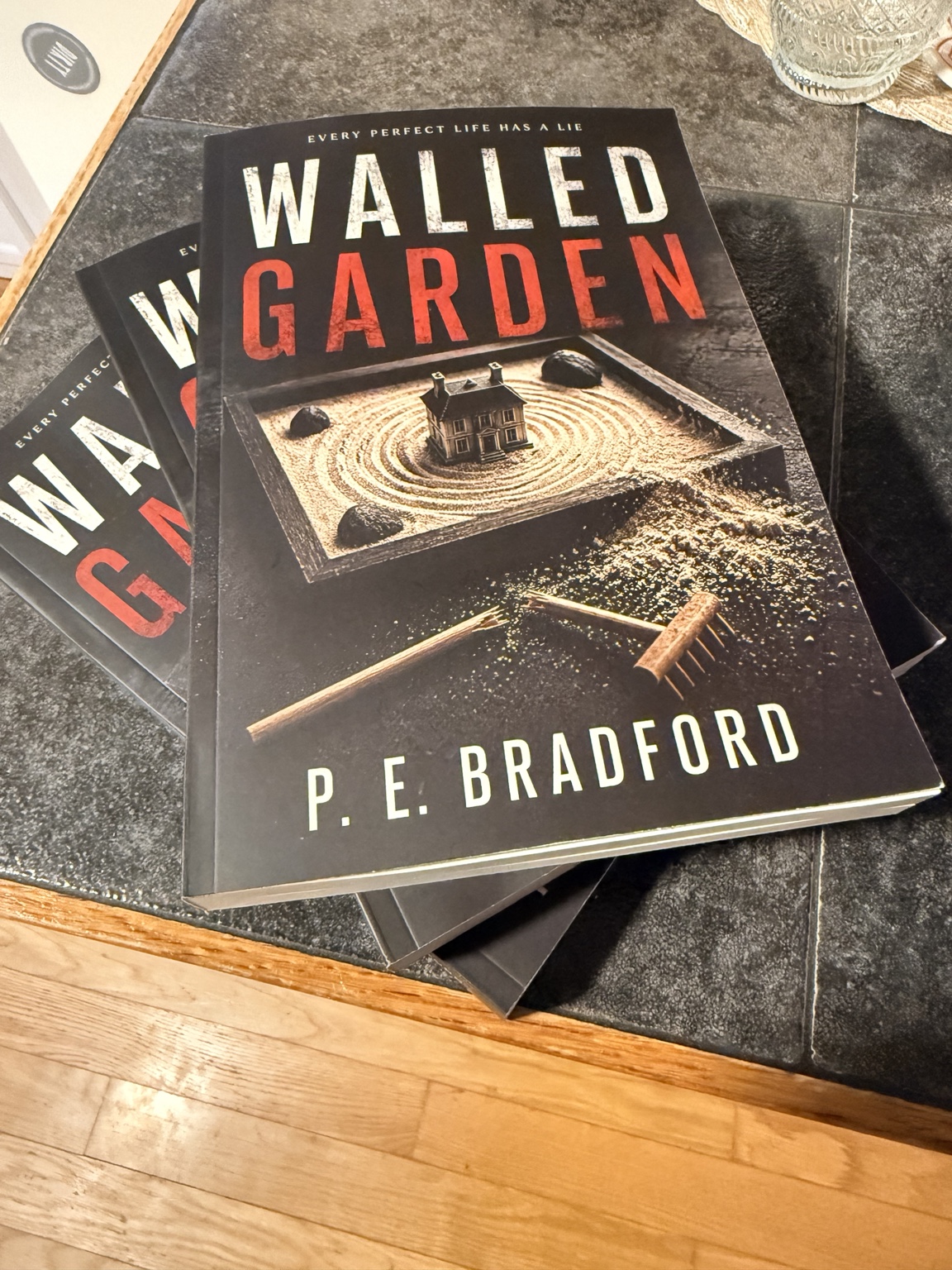 Advance paperback copies of Walled Garden by P. E. Bradford